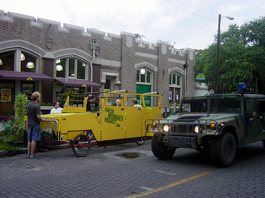 The Green Hummer and an army Humvee side by side on a downtown street