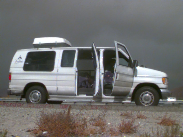 The Lost in America van parked by the road, with its doors open