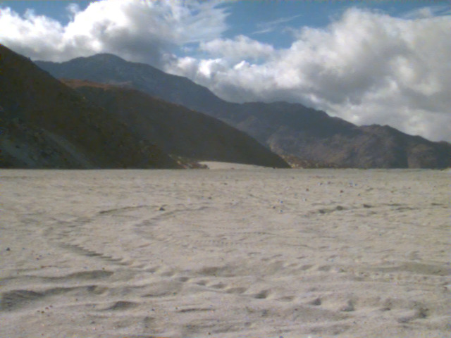 Sand dunes below a mountain range
